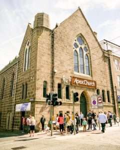 Our local Church building with people gathering outside